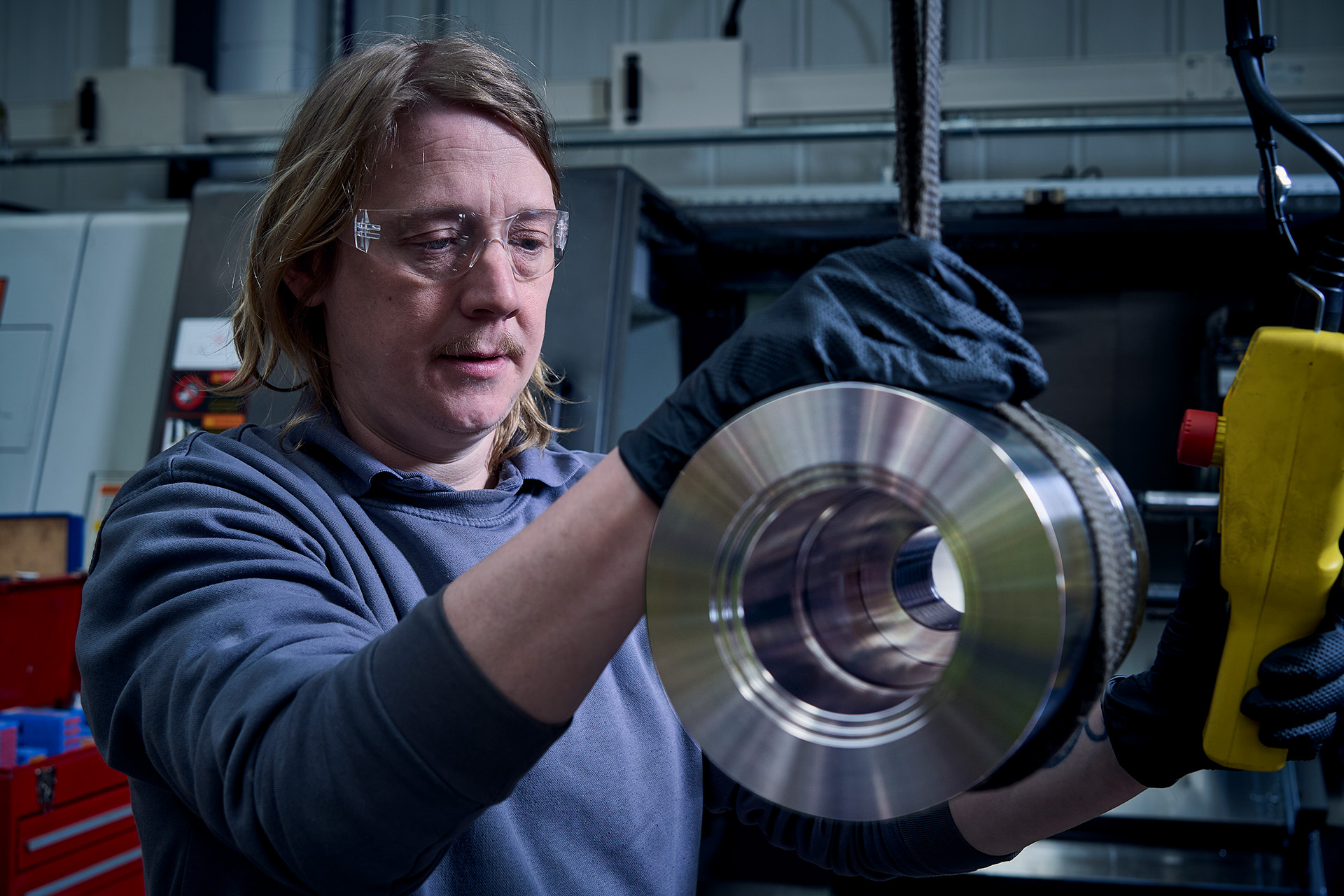 Colson Valves engineer carefully inspecting precision machined stainless steel valve body component in UK workshop
